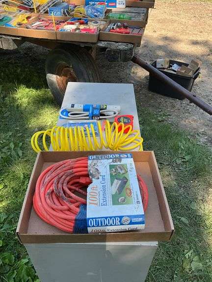 Flat with extension cords, power strip, tape measures, air hose