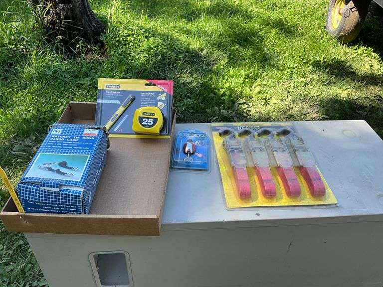 flat of tie down straps, tape measure & blade & LED keychain light