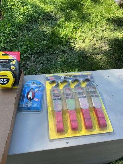 flat of tie down straps, tape measure & blade & LED keychain light
