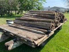 100- 6-7ft wood fence posts , wagon not included