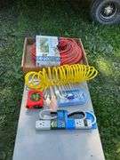 Flat with extension cords, power strip, tape measures, air hose