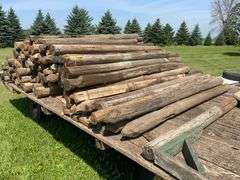 100- 6-7ft wood fence posts , wagon not included