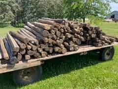 100- 6-7ft wood fence posts , wagon not included