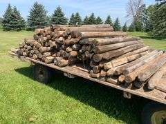100- 6-7ft wood fence posts , wagon not included