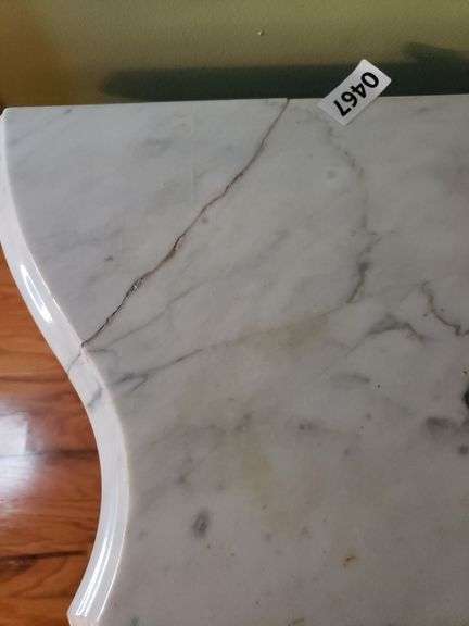 Harp base marble top table has a crack