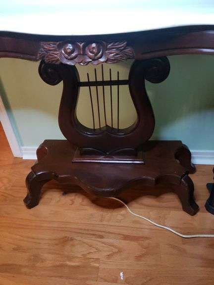 Harp base marble top table has a crack