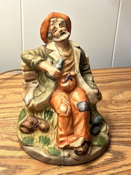 VINTAGE OLD MAN ON BENCH WITH LIQUOR BOTTLE