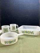Jeannette Glasbake set in the "Huckleberry" pattern, featuring a square baking dish, a small saucepa