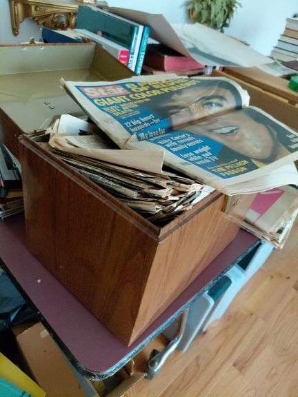 Metal box full of old newspapers