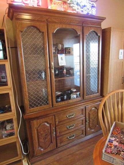 GLASS CHINA HUTCH W/ APPX 23 COFFEE MUGS - SEVERAL STURGIS RELATED MUGS - HUTCH MEASURES: 52" WIDE X 77" TALL - COMES APART IN TWO PIECES - LIGHTED