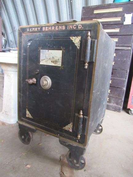 HENRY BEHRENS INC SAFE 25"X26"X39" TALL ON 6" IRON WHEELS - LOCKED - NO COMBO