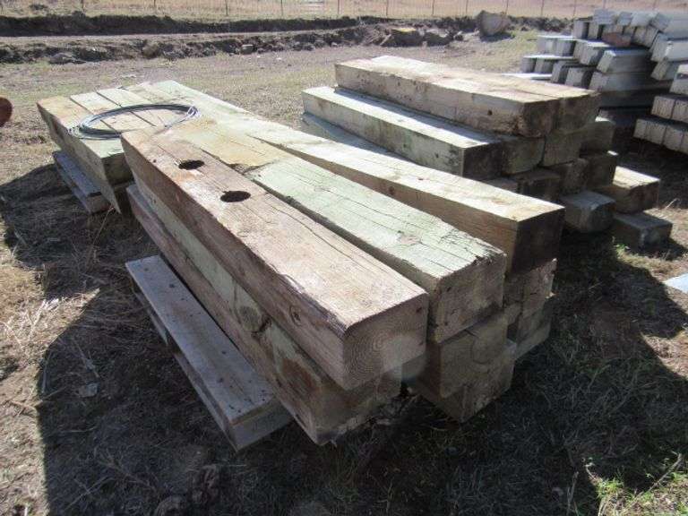 36 - 5 1/2" X 8" X 6' TREATED GUARD RAIL POSTS - McPherson Auction & Realty