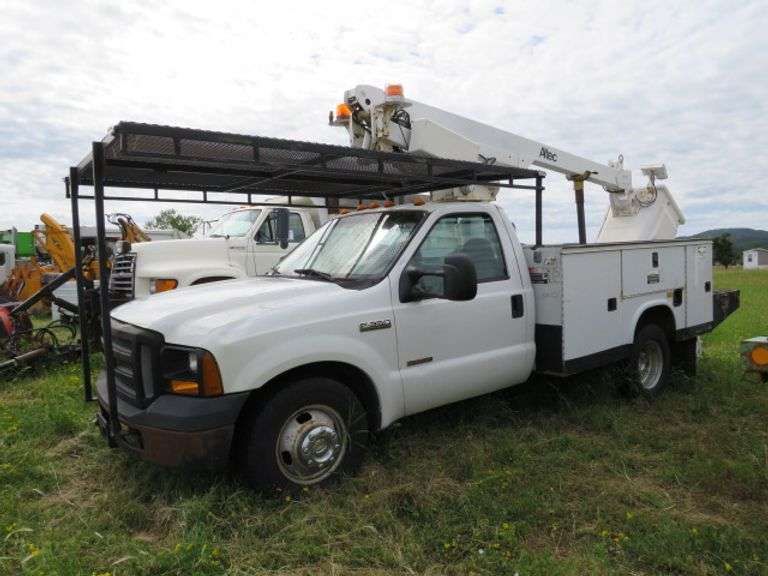 2006 Ford F350 1 Ton Service Box Truck with 2000 altec extendable boom/basket, 300lb capacity, 30.6 ft platform height. - extra basket - 9' utility box - 6.0 diesel engine - automatic transmission - 59,650 miles - sells with title - runs drives and operates  - VIN #1FDWF36P56EC35077