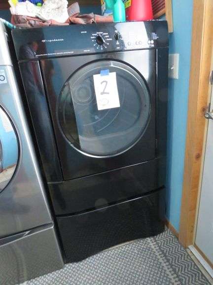 FRIGIDAIRE FRONT LOAD DRYER BLACK IN COLOR ON A PEDISTAL BASE