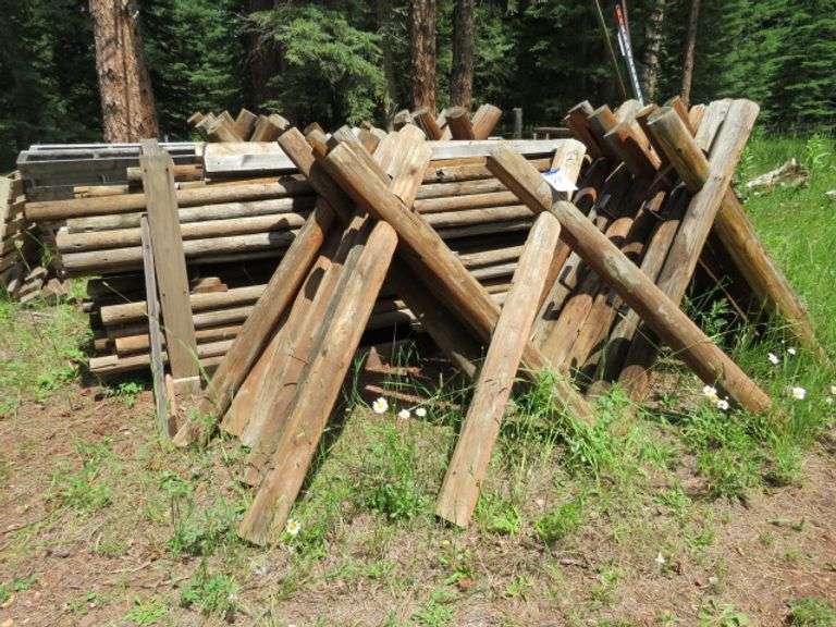 LARGE QUANTITY OF CROSS BUCK FENCE INCLUDES 29 TREATED CROSS BUCK STANDS AND A BUNDLE APPROX. 50  OF RAIL THAT ARE 12' LONG 3" DIAM. HAS ALL BEEN REMOVED STACKED AND READY FOR YOU TO LOAD - BRING HELP ALONG - BOBCAT ON SITE TO ASSIST