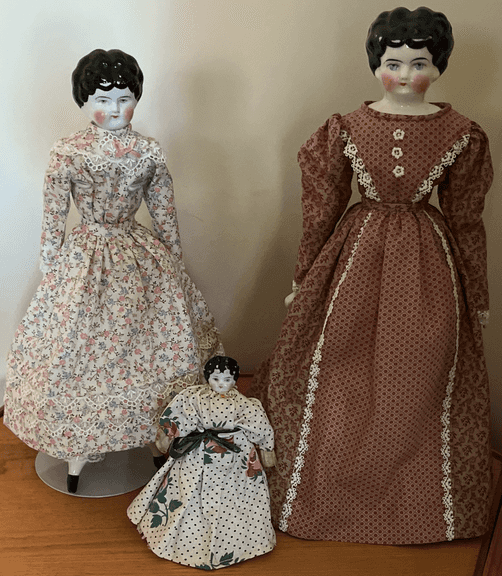 (3) Porcelain composite dolls with glass showcase: Dolls, 6",15,",16" Case 22x14x18"