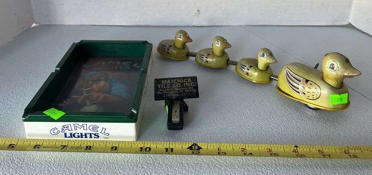 Camel lights ashtray, majenica clip, tin duck windup toy