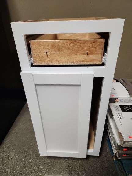 Base Cabinet in white 15" W x 24 D x 35"H is assembled incorrectly drawer front is off