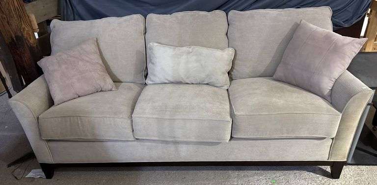 Three-Cushion Sofa with Textured Beige Upholstery and Throw Pillows