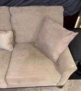 Three-Cushion Sofa with Textured Beige Upholstery and Throw Pillows