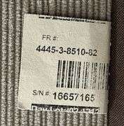 Three-Cushion Sofa with Textured Beige Upholstery and Throw Pillows