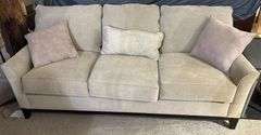 Three-Cushion Sofa with Textured Beige Upholstery and Throw Pillows