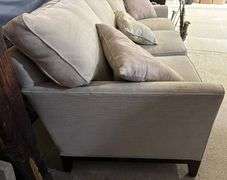 Three-Cushion Sofa with Textured Beige Upholstery and Throw Pillows