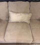 Three-Cushion Sofa with Textured Beige Upholstery and Throw Pillows
