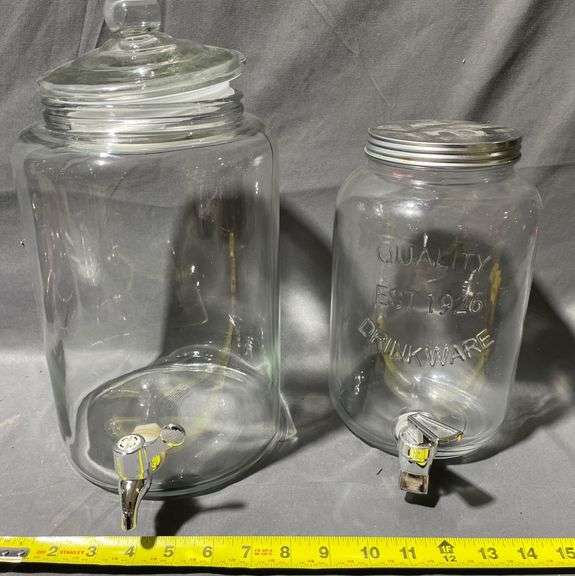 Two Clear Glass Beverage Dispensers with Spigots and Lids