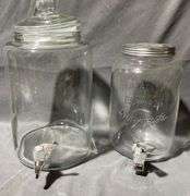 Two Clear Glass Beverage Dispensers with Spigots and Lids