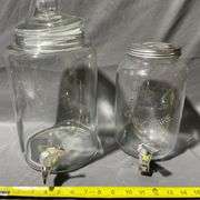 Two Clear Glass Beverage Dispensers with Spigots and Lids