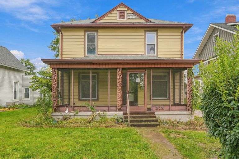 Two-Story Home Featuring 4 Bedrooms, 2 Baths with Classic Character, Enclosed Porches, and Two Garages!