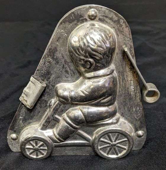 ANTIQUE CHOCOLATE MOLD BOY CHILD ON WHEELED VEHICLE ANTON REICHE DRESDEN