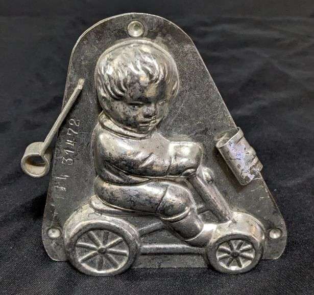 ANTIQUE CHOCOLATE MOLD BOY CHILD ON WHEELED VEHICLE ANTON REICHE DRESDEN