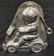 ANTIQUE CHOCOLATE MOLD BOY CHILD ON WHEELED VEHICLE ANTON REICHE DRESDEN