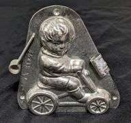 ANTIQUE CHOCOLATE MOLD BOY CHILD ON WHEELED VEHICLE ANTON REICHE DRESDEN
