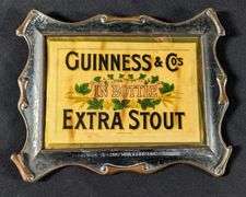 CELLULOID BEER SIGN GUINESS & CO'S EXTRA STOUT IN BOTTLE