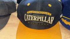 Variety of  New or Lightly Used Trucker Hats with NRA, Caterpillar, and WordPerfect Designs