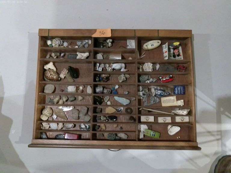 Wooden wall display case. Multiple small collectibles included. Located in basement.