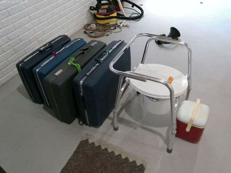 Bedside toilet, small igloo, cooler three Samsonite hard suitcases, and one or forcast hard suitcase