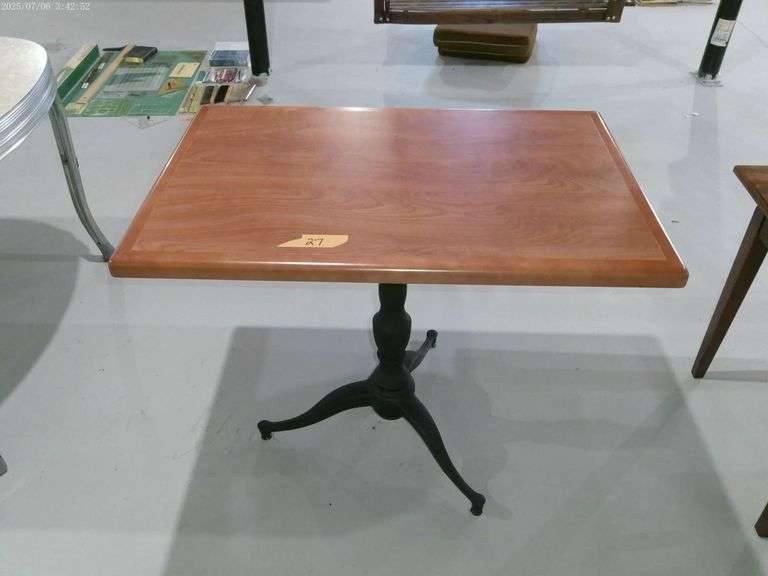 Wood top table with iron base. 2 ft. X 3 ft. X 2.5 ft. tall. Located in basement.