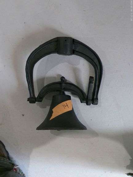 Cast iron bell with yoke. Bell is 7 inch circumference x 5 inches tall. Located in basement.
