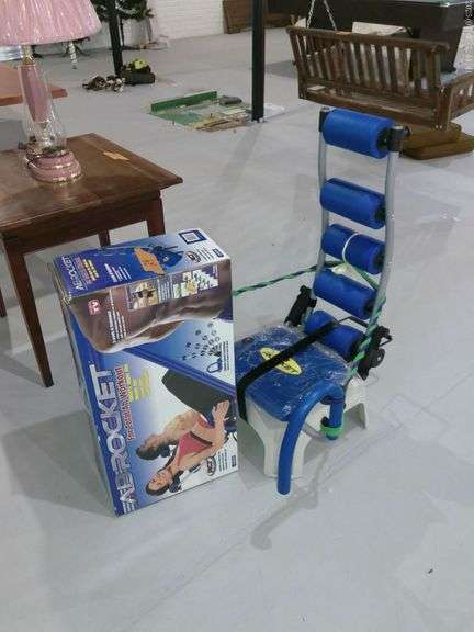 Ab rocket exercisor with box. Small step stool. Located in basement.