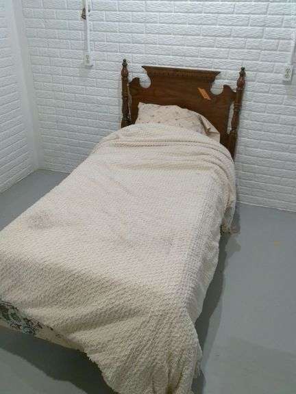 Twin bed with wood headboard. Comes with older mattress and box springs. Located in basement.