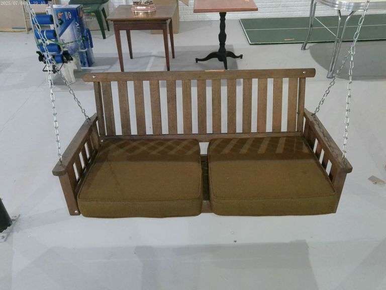 Wooden hanging porch swing. 4 feet wide. Located in basement.
