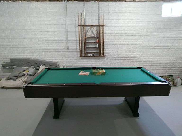 Pool table with rack and balls. Brandywine table, six cue sticks included. Located in basement.