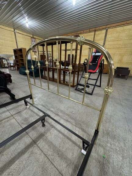Queen bed frame with brass colored headboard.