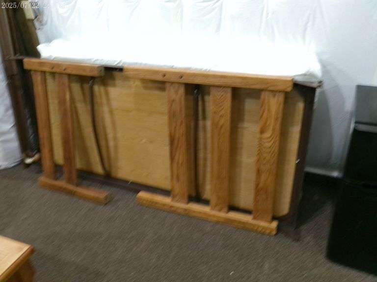 Twin sized bed with wooden head and foot board