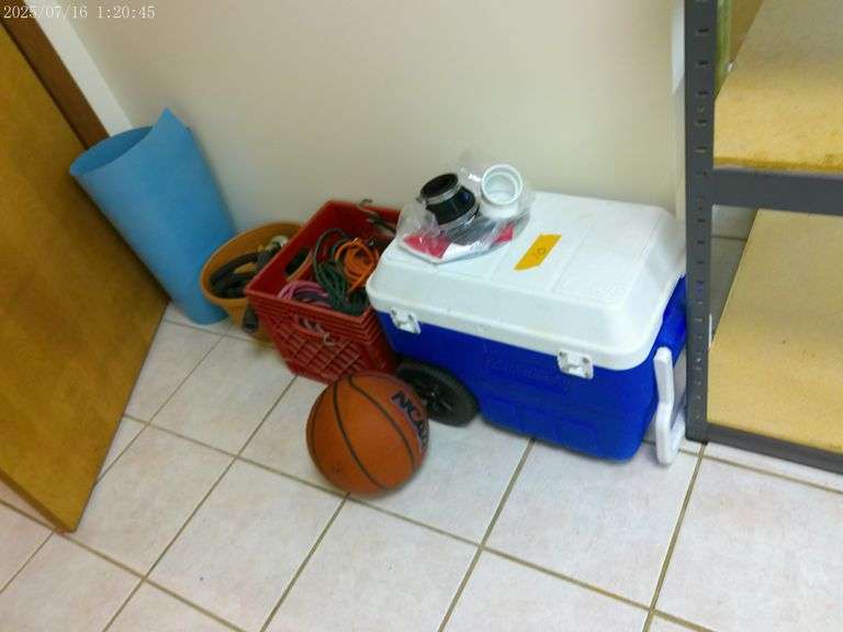 Coleman pull type cooler, extension cords, Wilson basketball, hose and sprayer. In basement