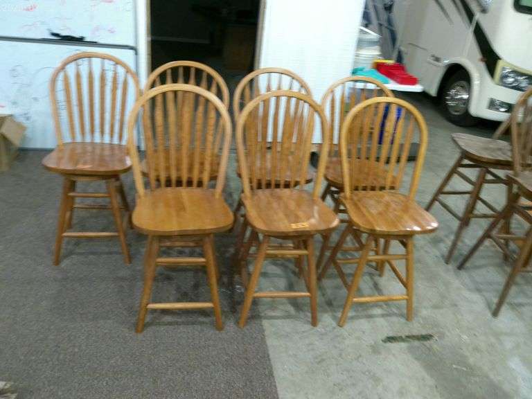 7 oak swivel barstools, 1 chair has stained finish